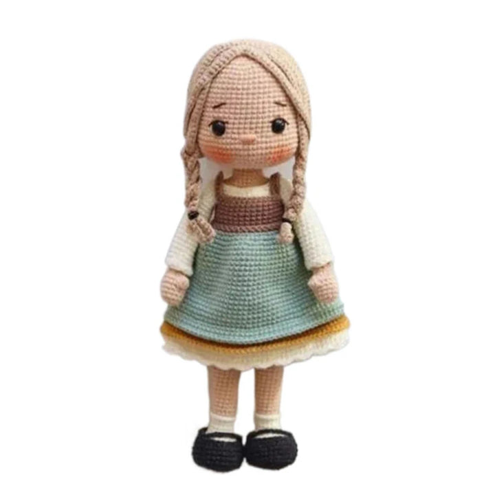 Crocheted doll with long blonde hair and a dress on a white background