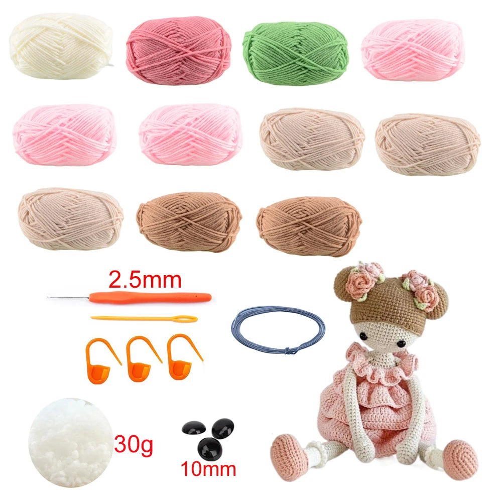 Collection of yarn balls in various colors, crochet hooks, and a crocheted doll on a white background.