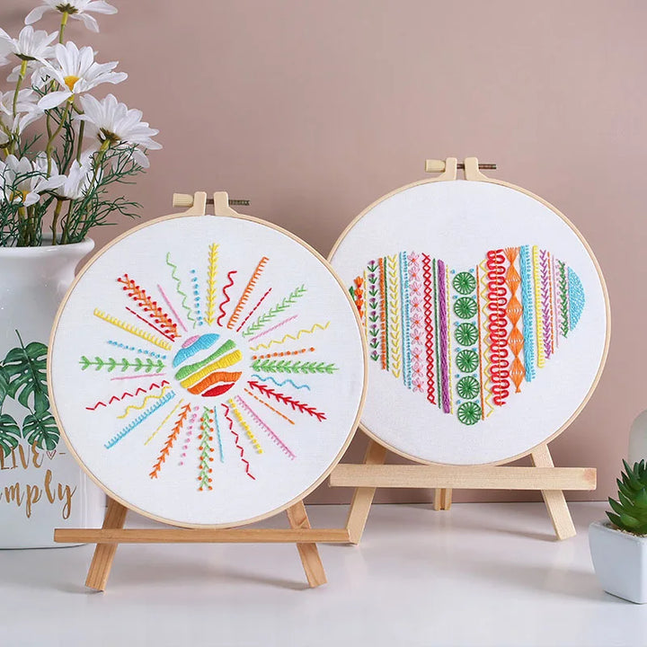 Two embroidery hoops with colorful patterns on a neutral background
