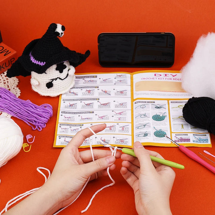 Person crocheting with a DIY crochet kit on an orange surface
