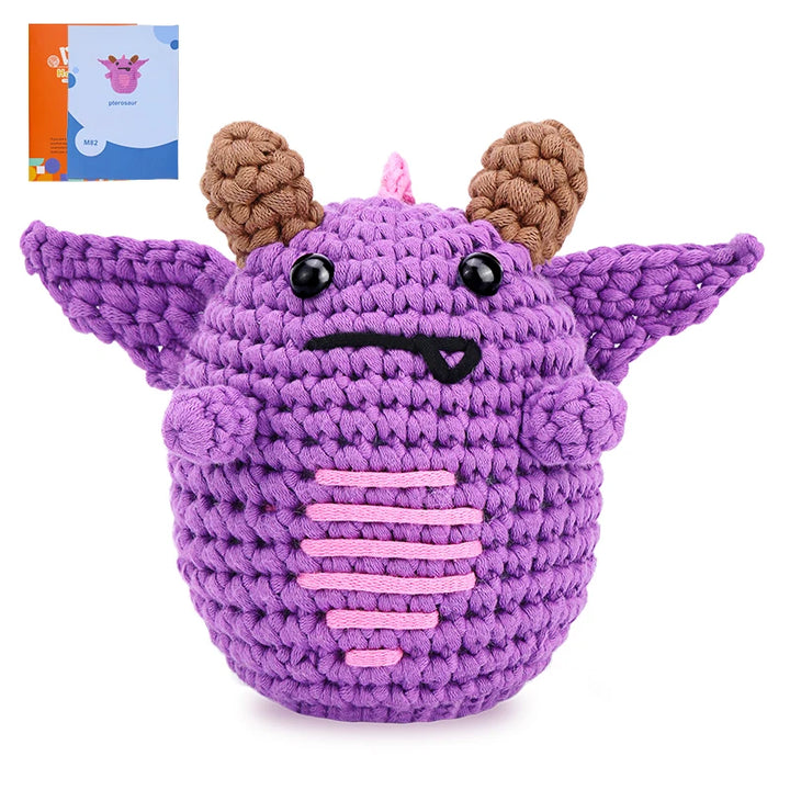 Purple crochet toy with brown horns on a white background