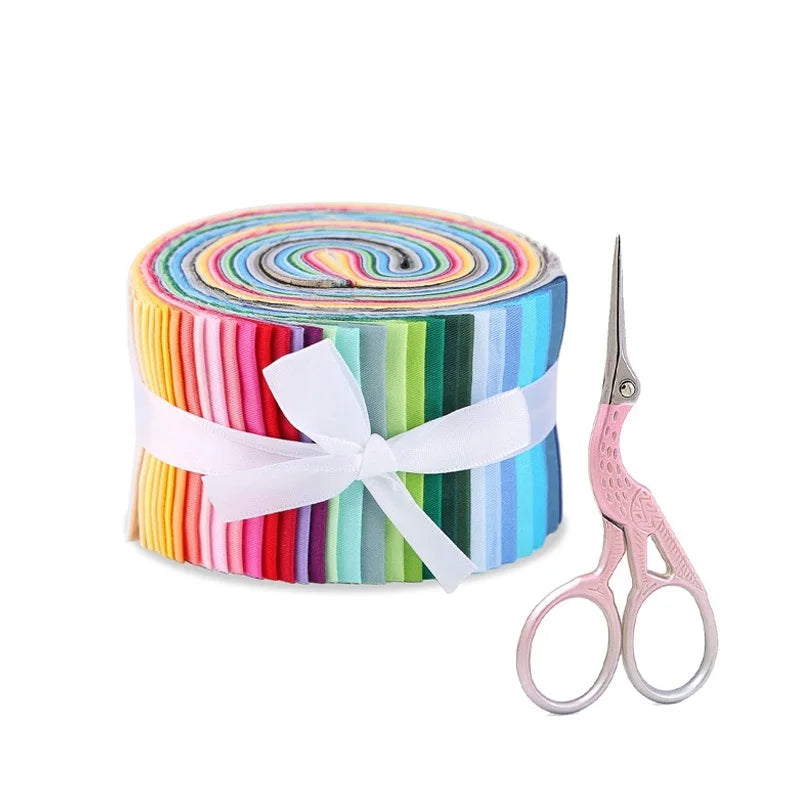 Roll of colorful fabric with a white bow and pink scissors on a white background