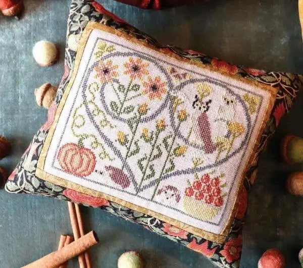 Decorative pillow with floral and leaf pattern on a textured surface
