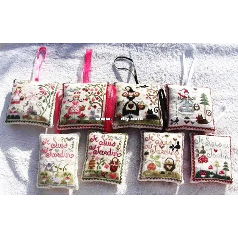 Set of embroidered fabric pouches with various designs on a white background