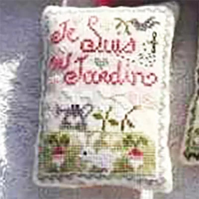 Decorative pillow with cross-stitched design featuring text and illustrations on a textured surface.