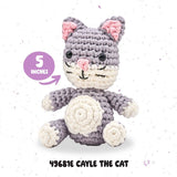 Crocheted cat toy with gray and white colors on a light speckled background