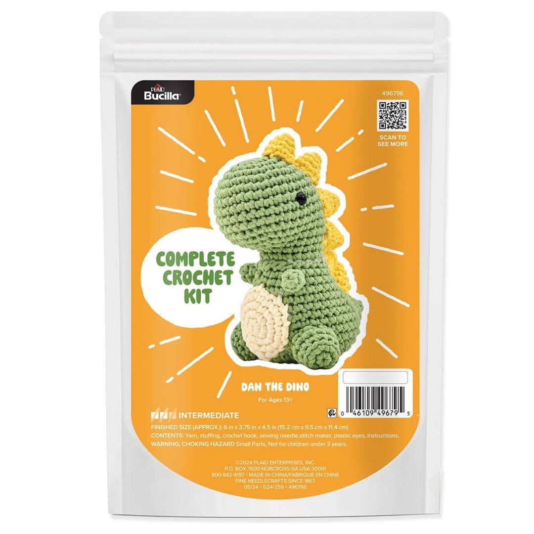 Bucilla crochet kit packaging with a green dinosaur toy on an orange background