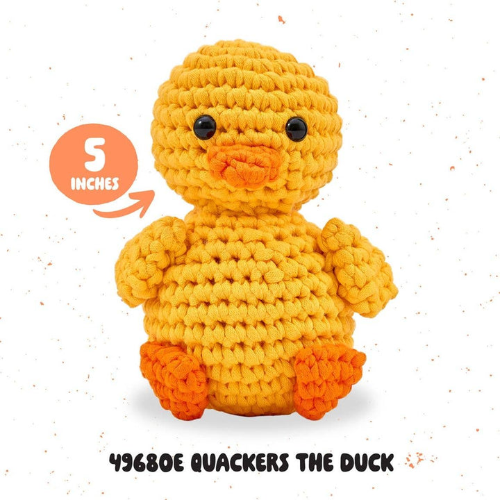 Crocheted duck toy with size label and product code on a white background