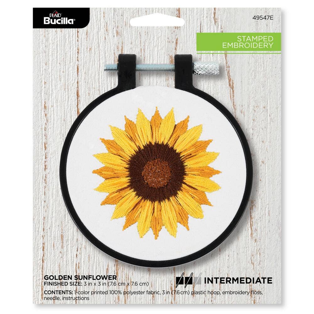 Embroidery hoop with a pre-stamped golden sunflower design on a white background, branded with Bucilla.