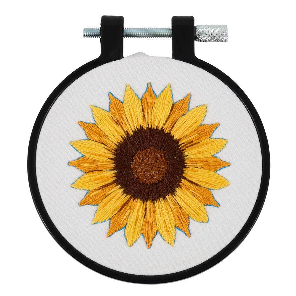 Embroidery hoop with a sunflower design on a white background