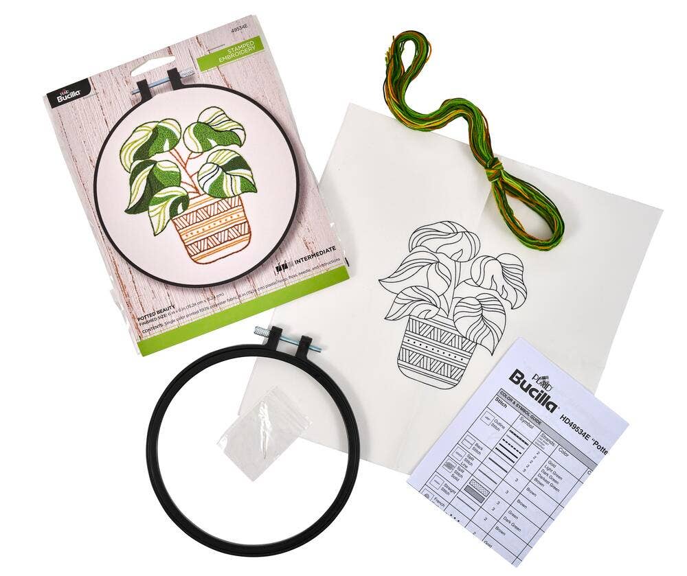 Embroidery kit with hoop, plant design, and pattern sheet on a white background