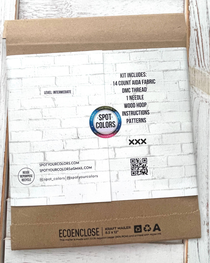 Package with 'Spot Colors' branding on a white brick wall background