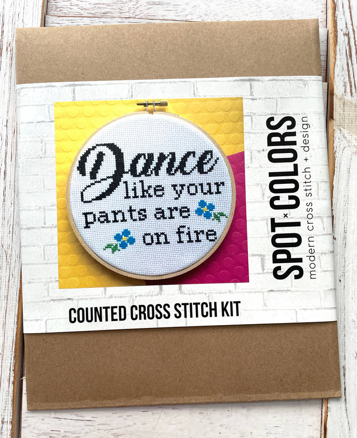 Counted cross stitch kit with embroidery hoop and colorful design on a white background