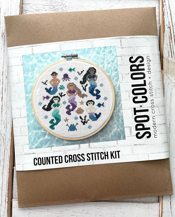 Counted cross stitch kit with mermaid design on a white background