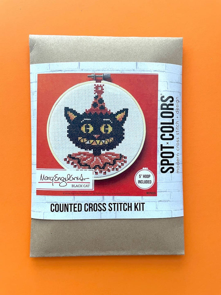 Counted cross stitch kit packaging with a black cat design on an orange background