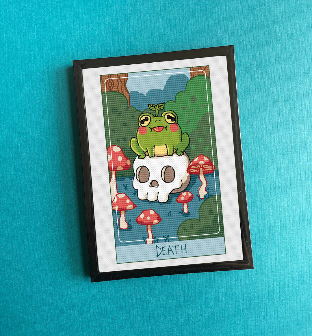 Framed artwork with a cartoon frog on a skull surrounded by mushrooms against a blue background