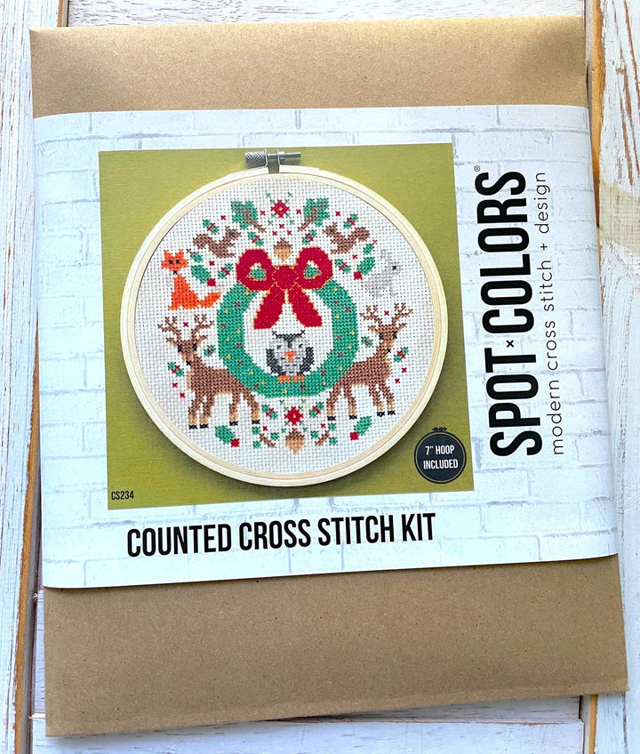 Counted cross stitch kit with a festive design on a cardboard backing